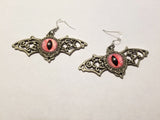 Silver winged pink eyed earrings