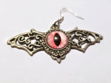 Silver winged pink eyed earrings