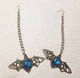 Long chain silver winged blue eye earrings