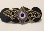 Silver winged purple eye hair clip